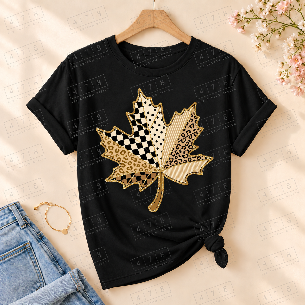 Neutral patchwork leaf on a black knotted T-shirt