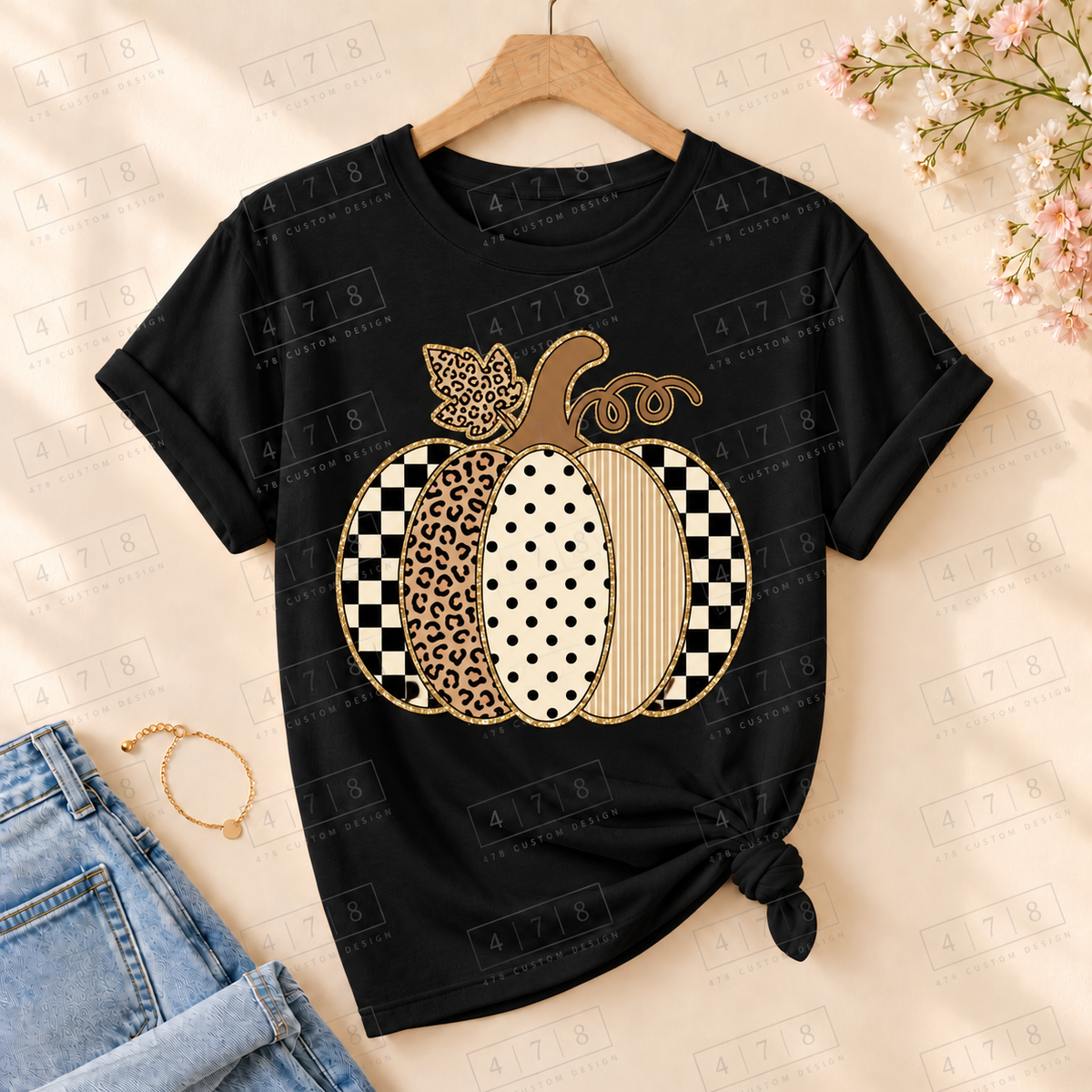 Neutral patchwork pumpkin on a black knotted T-shirt