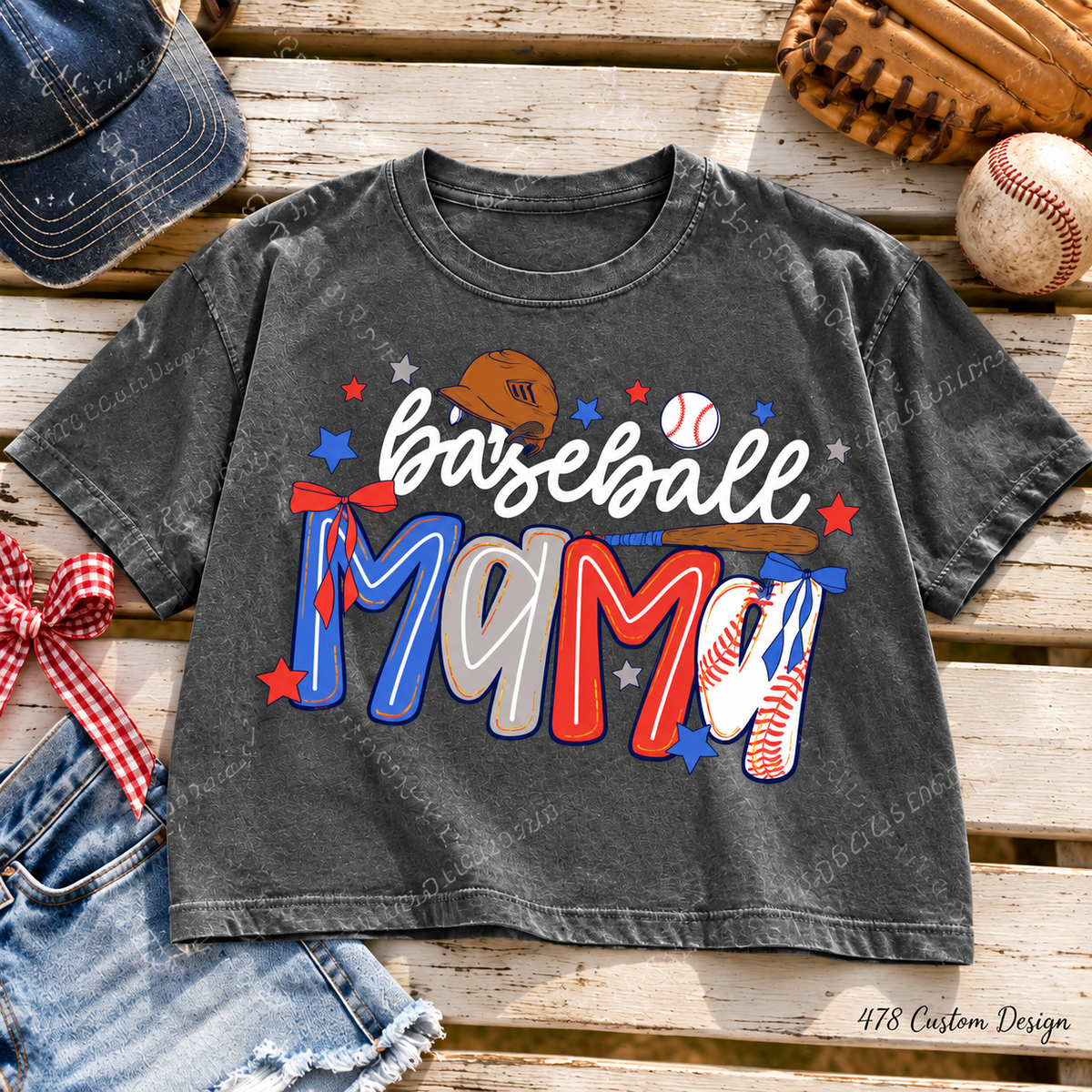 Preppy Baseball Mama design with red, white and blue lettering, bows, stars and baseball details. Shown on a pepper Comfort Colors boxy crop tee. Any glitter effect is printed faux glitter.