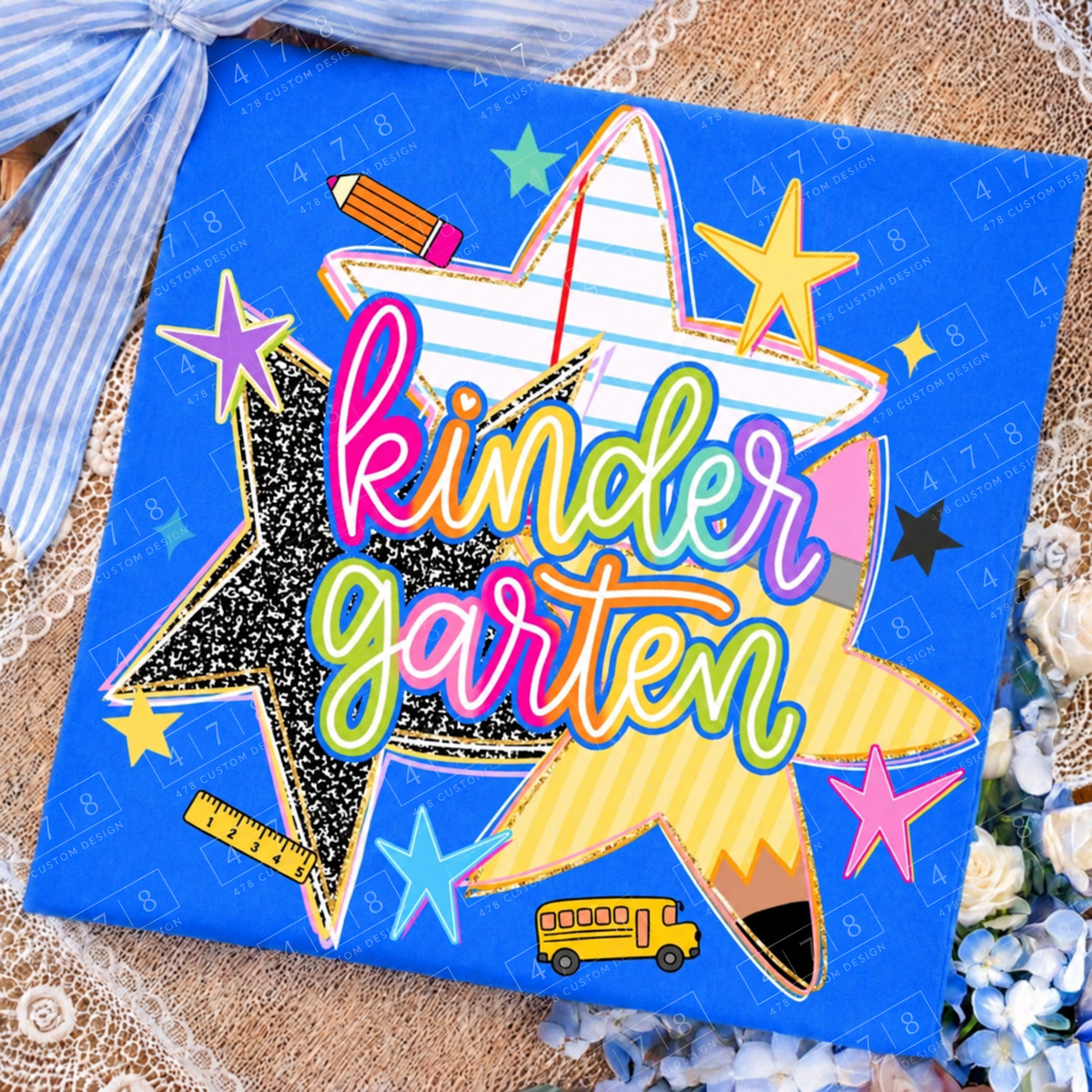 Kindergarten rainbow school stars design on a royal blue folded shirt