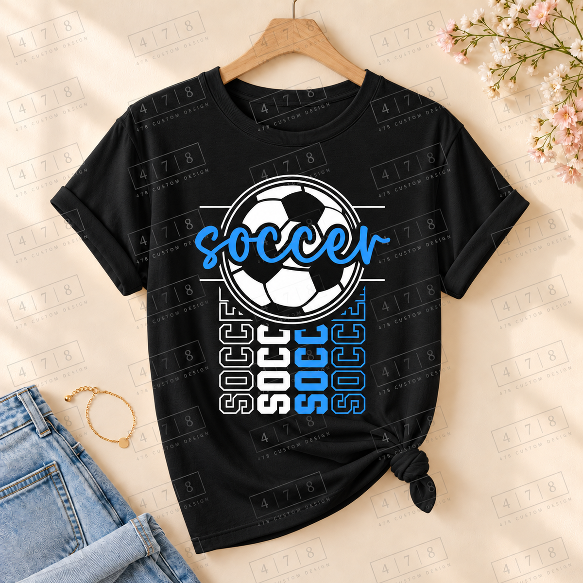 Blue Script Soccer Ball Top on a black T-shirt