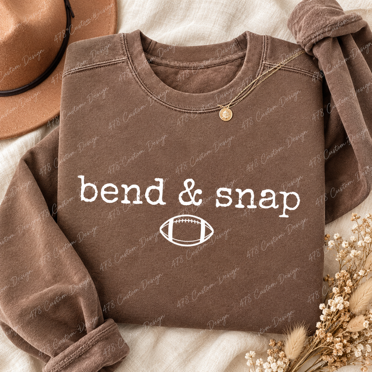 Bend and snap white football design on a brown crewneck sweatshirt