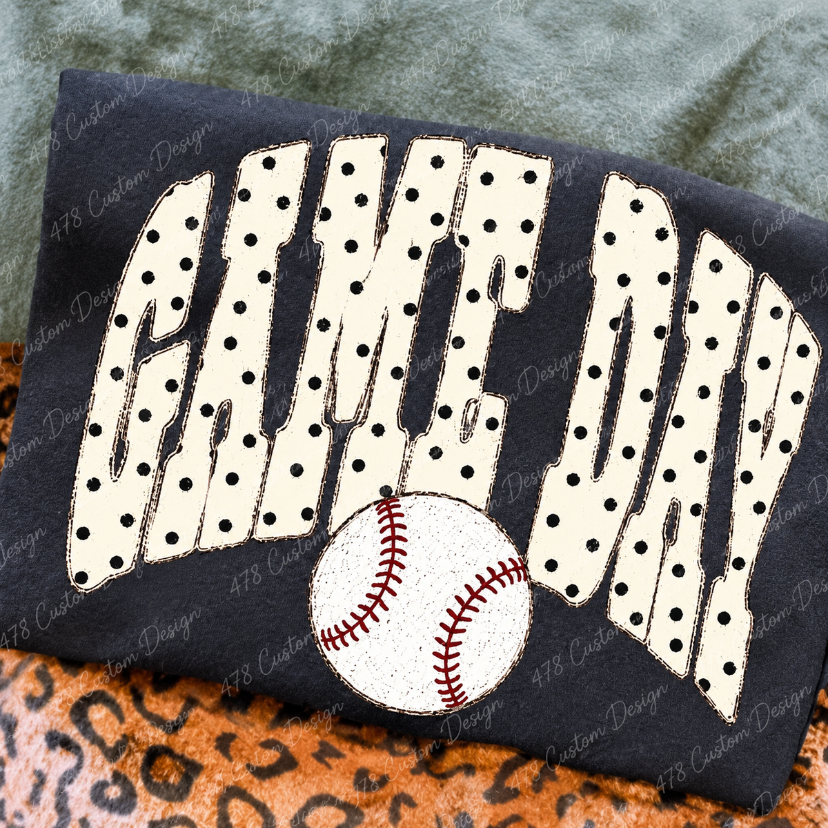 Polka Dot Game Day Baseball design on a folded charcoal shirt