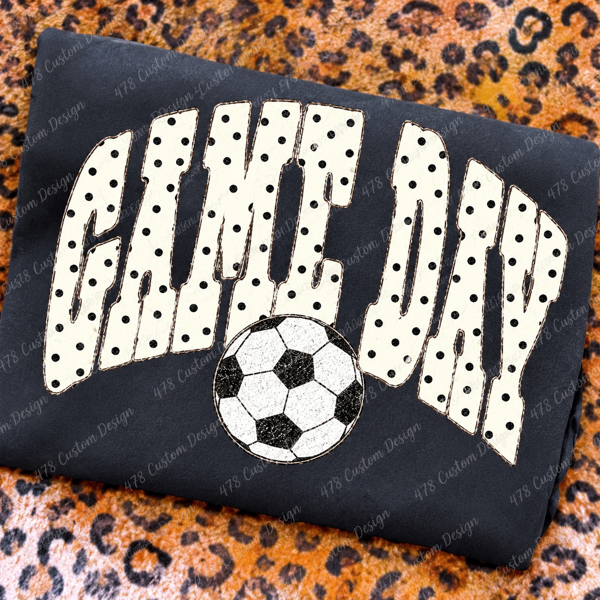 Polka Dot Game Day Soccer design on a folded charcoal shirt